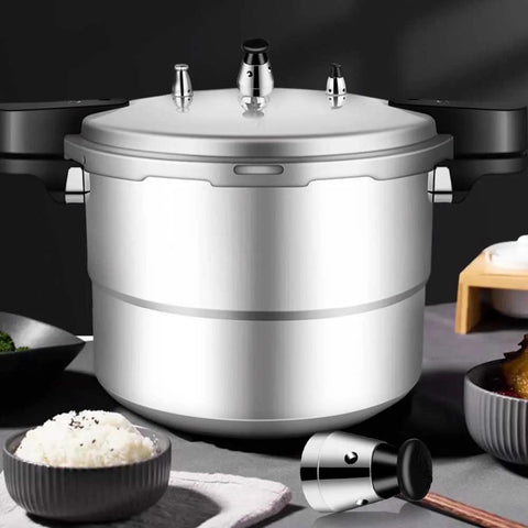 Stainless steel pressure cooker with jigger relief valve set on lid; detached valve component beside it.