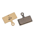 Heavy Duty Disc Brake Pads Crafted For Badass Stopping Power And Tight Control On Mountain Bikes Featuring Whisper Quiet Operation That Keeps The Ride Solid In Wet Or Dry Conditions - golden and dark gray pads with backing plates.