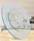 Rotating Tempered Glass Lazy Susan Turntable For Large Dining Tables on wooden surface, clear glass, 360 degree rotation feature visible.