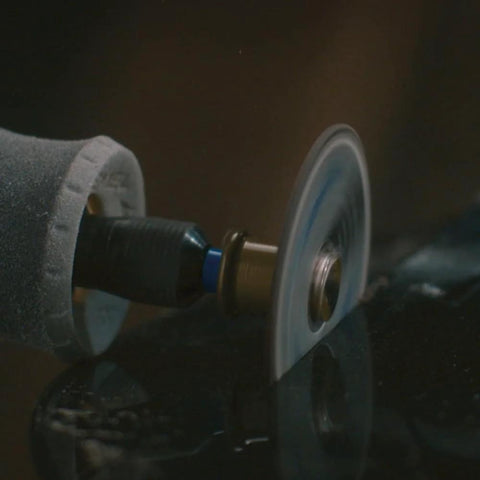 Dremel EZ Lock cutting disc mounted on a rotary tool, side view.