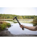 22 Oz Workhorse Framing Hammer With Magnetic Nail Starter held by hand outdoors near a lake, showcasing rip claw and milled face
