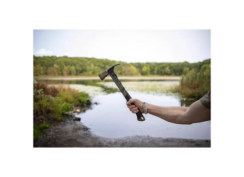 22 Oz Workhorse Framing Hammer With Magnetic Nail Starter held by hand outdoors near a lake, showcasing rip claw and milled face