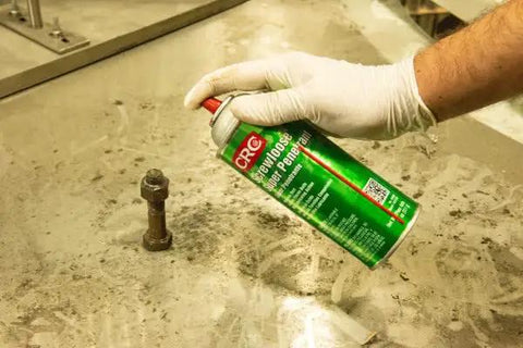 Person spraying Super Penetrant Aerosol For Corroded Fasteners And Seized Mechanical Components Plastic Safe Formula