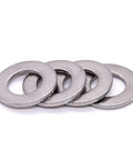 Front view: stainless steel flat washers, 1/4 in ID, 0.63 in OD, bright finish, four shown