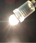 Close-up of Snag A Box Of Ten E10 Miniature Screw Base Bulbs Rated At 4.5 Volts With 1.35 Watt Incandescent Filament glowing.