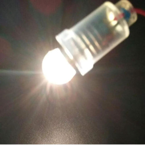 Close-up of Snag A Box Of Ten E10 Miniature Screw Base Bulbs Rated At 4.5 Volts With 1.35 Watt Incandescent Filament glowing.