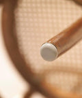 Close-up of a chair leg with a white Peel And Stick Furniture Sliders Value Pack For Carpet Floors for smooth movement.