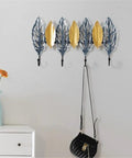 Big Letter Wall Mount Coat Hook Heavy Duty Entryway Key Organizer Sturdy Home Storage Rack With Durable Matte Finish hung with bags, featuring decorative leaf design.