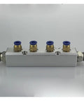 Four Way Pneumatic Air Manifold Kit With 30x30mm Push Fit Couplers on reflective surface showing four outlets
