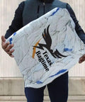 Person holding a large pack of Texas Ragtime rags wrapped in clear packaging, designed for cleaning purposes in various environments.