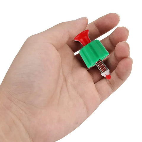 Pressure relief valve with green plastic body, red knob, and threaded metal stem for garden sprayer.
