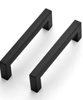 Two matte black handles from the 12 Pack Square Cabinet Handles 4.5 Inch Center To Center Matte Black Drawer Pulls For Cabinets Cupboards And Drawers Kitchen Hardware Durable Stainless Steel Construction With Easy Mounting Holes Ideal Replacement For Modern Kitchens.