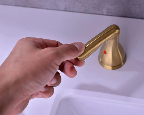 Two-Handle 8-Inch Gold Widespread Bathroom Faucet With Pop-Up Drain in use, Brushed Gold Finish, close-up of handle