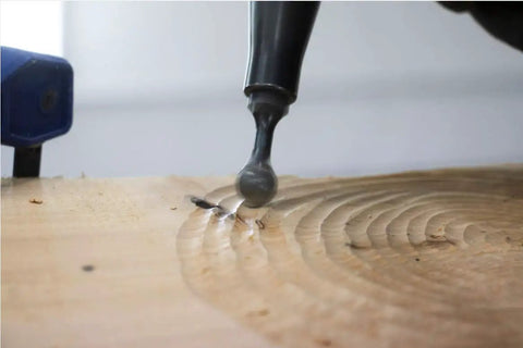 Close-up of mini ball gouge from Three Piece Pro Grade Precision Power Carving Attachment Set shaping wood surface