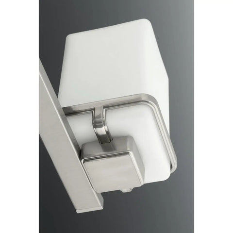 Close-up of 3 Light Coastal Style Vanity Light for Bathroom with Etched White Glass Shade and Brushed Nickel Finish.