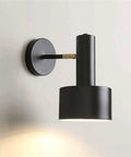 Modern Nordic Black Metal Wall Sconce Adjustable E26LED Spotlight Bedside Reading Lamp Minimalist Industrial Style Accent Lighting Fixture for Bedroom Living Room Hallway(Black) with cylindrical head and round plate.