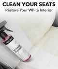 Tesla Seat Cleaner And Stain Remover For Black And White Vegan Leather Interior bottle on car seat
