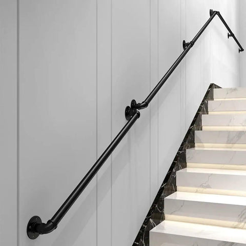 Rock Solid Seven Feet Industrial Stair Handrail Featuring Non Slip Black Iron Pipe Construction For Wall Mounted Garage Steps Vintage Loft Porch And Real Deal Home Safety Upgrade mounted on white wall alongside marble staircase.
