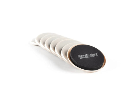 Stack of Medium Round Reusable Carpet Furniture Sliders Set Of Sixteen Three And A Half Inch Anti Slip Moving Pads in beige.