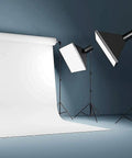 Studio setup with Heavy Duty Light Stand 9.5 Feet Adjustable Tripod for Photo Studio Gear and softbox lights on seamless backdrop