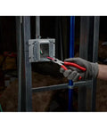 Gloved hand using 8-Inch Long Nose Pliers With Reaming Head And Onboard Fish Tape Pulling, 2-Inch Reach And Notched Teeth For Solid Grip, Reams Pipes Up To 1.5-Inches, Versatile Electrician And Plumbing Tool For Tight Work on wiring in a metal junction box.