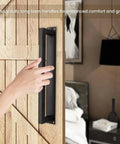 Rustic 12 Inch Barn Door Handle installed on a wooden door, heavy duty matte black square door pull with long flush base.