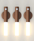 Indoor Wall Sconce Equipped With Smart Motion Detection And An Extra Large 2200mAh Rechargeable Battery, showcasing three wooden motion sensor lanterns.