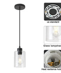Dimmable Black Farmhouse Glass Cylinder Pendant Light for Kitchen Island Clear Glass Mini Pendant Fixture with 4.75 Inch Shade and Dual 58 Inch Cords Ideal for Modern Dining and Bar Areas Pack of 3, showing clear glass lampshade and ceiling mount.