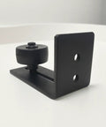 Heavy Duty Sliding Barn Door Floor Guide For Closets And Room Dividers Rock Solid Steel Runner Matte Black Finish side view of compact guide with wheel