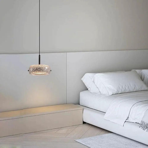Resin Pendant Light, Gold 3 Color LED Hanging Fixture for Living Room, crystal textured shade above a bed in a modern bedroom.