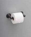 Providence Spring Toilet Paper Holder Wall Mounted With SpotShield Venetian Bronze Finish holding toilet roll on gray wall