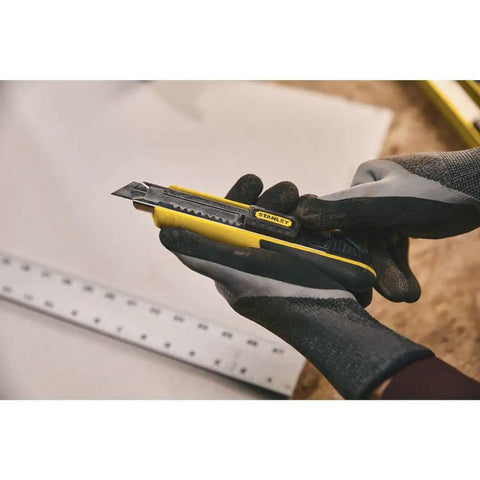 Person using FatMax Snap-Off Knife 18mm Heavy Duty Utility Knife with Rust-Resistant Stainless Barrel for precise cutting