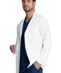 Man wearing a Men's 30 Inch Lab Coat White Consultation Coat With Durable Mechanical Stretch Fabric and modern fit in a clinic setting.