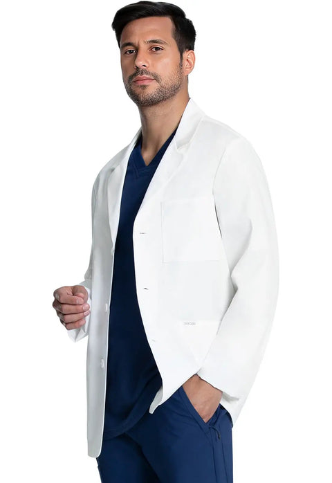 Man wearing a Men's 30 Inch Lab Coat White Consultation Coat With Durable Mechanical Stretch Fabric and modern fit in a clinic setting.