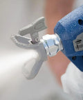 Professional Corded Airless Paint Sprayer With Triax Triple Piston Pump And Smart Control Dial spraying fine mist from nozzle.