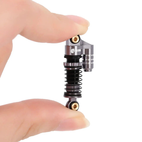 39mm Aluminum Threaded Adjustable Oil Filled Damper Shocks for SCX24 RC Crawler Fits Gladiator C10 JLU Deadbolt B17 Axial 1 24 Scale Upgrades Gray Finish with Preload Adjustable and Three Spring Rates for Smooth Damping and Beefed Aluminum Body held between fingers showcasing size