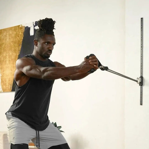 Top Tier Space Saving Home Gym Resistance Band System With Gliding Wall Track Three Foot Aluminum Mount And Five Bands Plus Handles in use.