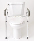 Solid Adjustable Toilet Safety Rails For Seniors Offering Smooth Bailout Support With Non Slip Padded Arms Heavy Duty 300 LB Capacity Top Shelf Bathroom Assist Bars Commode Seat Frame next to a toilet.