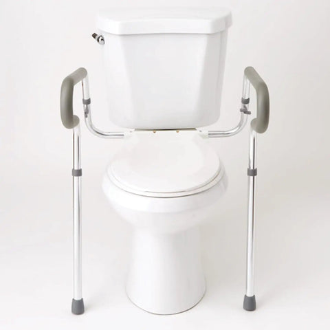 Solid Adjustable Toilet Safety Rails For Seniors Offering Smooth Bailout Support With Non Slip Padded Arms Heavy Duty 300 LB Capacity Top Shelf Bathroom Assist Bars Commode Seat Frame next to a toilet.