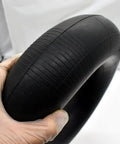 Close-up of Heavy Duty 5.00-6 Inner Tube With TR87 Bent Valve Stem For 13X5.00-6 And 12X5.00-6 Tires, held in gloved hand.