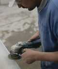 Person using Workhorse High-Power 4 1/2 Inch Angle Grinder With SJS Mechanical Clutch, 13 Amp Variable Speed for stone grinding