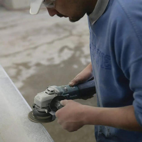 Person using Workhorse High-Power 4 1/2 Inch Angle Grinder With SJS Mechanical Clutch, 13 Amp Variable Speed for stone grinding