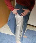 Person demonstrating Dope Conductive Silver Fabric for EMI Shielding and Wearable Tech Projects on leg, showcasing flexibility.