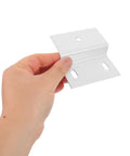 Hand holding a heavy duty Z shaped shelf bracket for cabinets and tile walls, moisture-proof iron right-angle fastener, 2 pack.