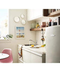 Refurbished Single Handle Faucet Kit LL, Tested and Certified Like New, in a modern kitchen setting with white cabinetry and plants.