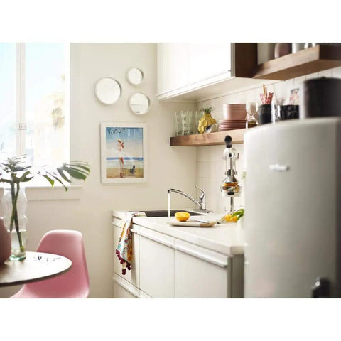 Refurbished Single Handle Faucet Kit LL, Tested and Certified Like New, in a modern kitchen setting with white cabinetry and plants.