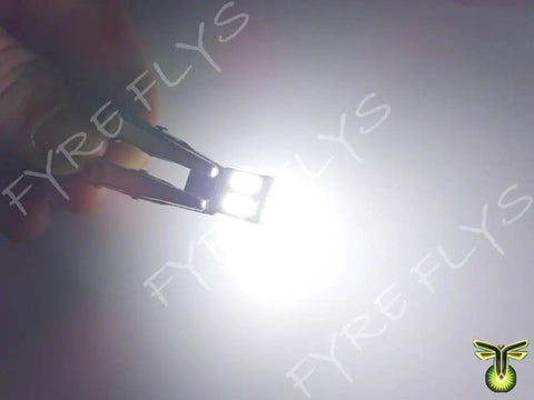 Error Free LED T10 Bulbs For Mercedes W204 C300 C350 Eyebrow And Eyelid Lights held showing bright white light