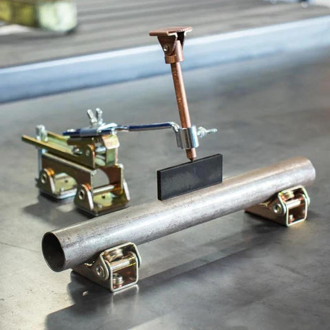 Deluxe Magnetic Grasshopper welding finger with copper spindle and magnetic V‑pad base on a metal pipe (front view).