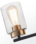 Close-up of Vintage Vibe 31 Inch Bathroom Vanity Light Fixture With Four Lights Seeded Glass Shades Gold Lamp Base On Black Metal Backplate