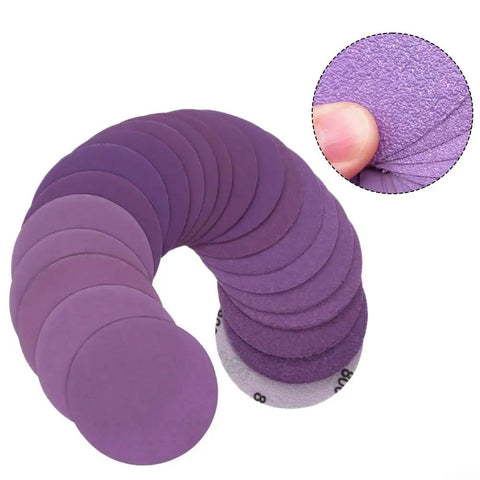 Check Out These Badass 3 Inch Sanding Discs With 320 Grit Aluminum Oxide Abrasive For Wet Dry Sanding And Waterproof Latex Backing Plus Hook System For Long Life On All Your Projects - Assorted purple sanding discs arranged in a spiral.